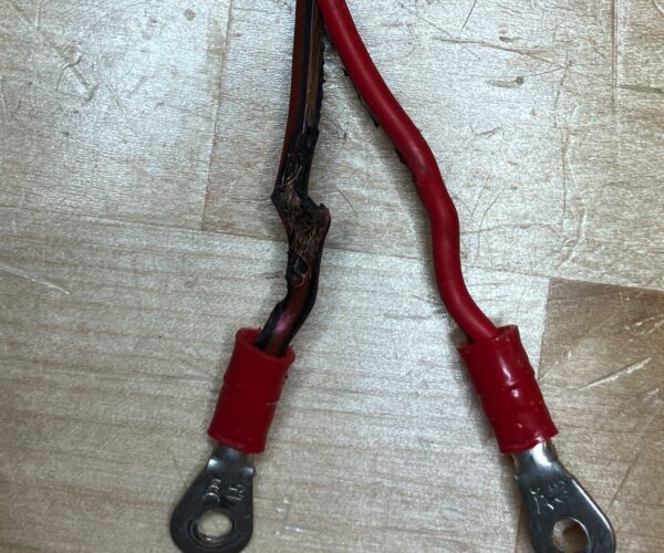 Damaged DC conductor with melted PVC coating showing fire risk hazard