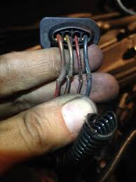 Heat damage causing hardened and cracked conductor sheathing with exposed wires