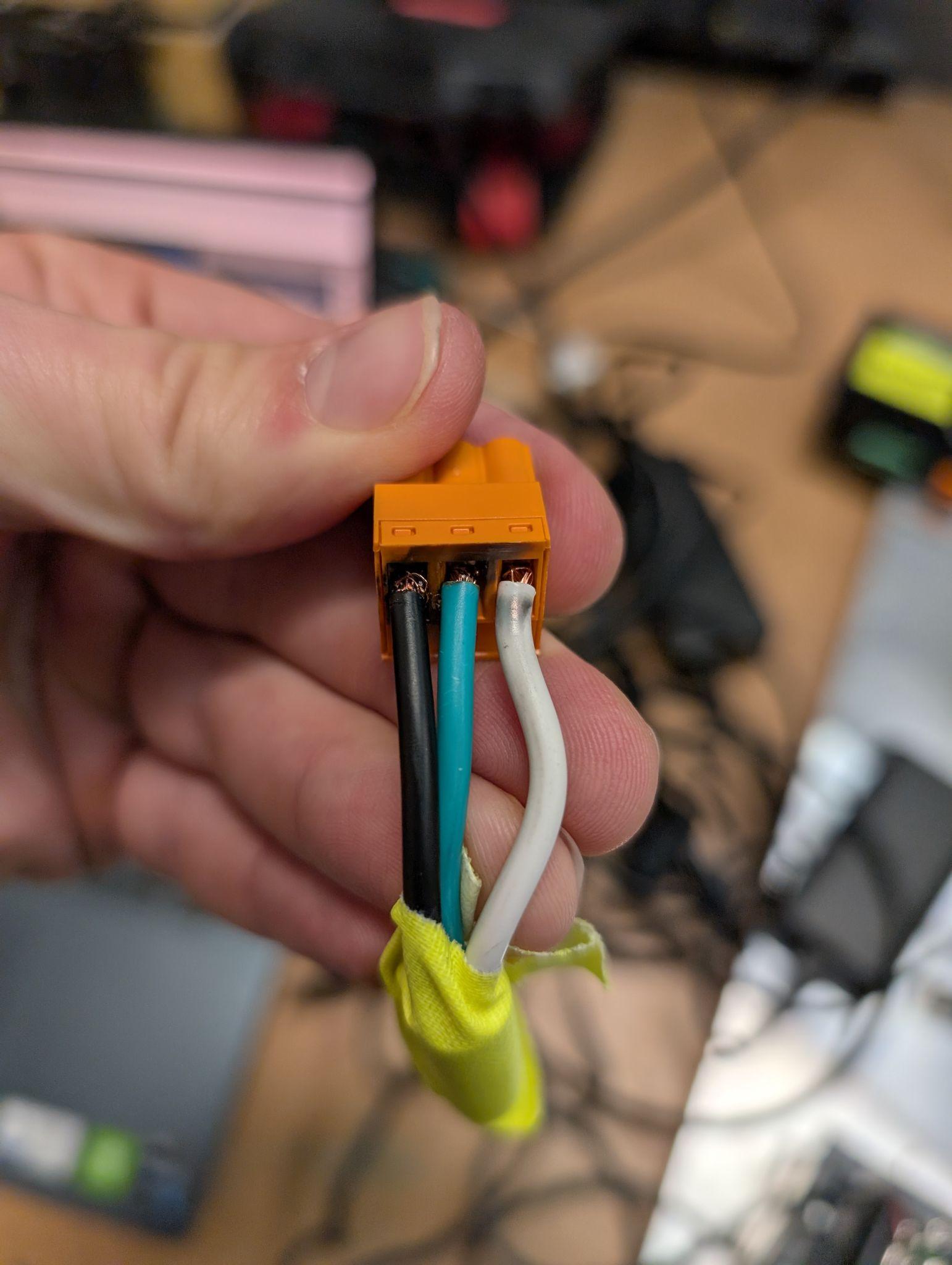 Arc-flash damage showing severe burning and melting of a terminal block connector from electrical arc incident